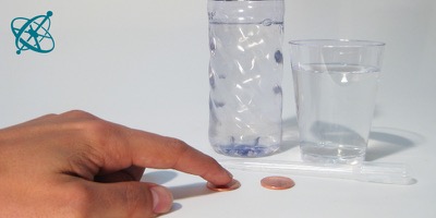 Sciensation hands-on experiment for school: Drops on a coin ( chemistry, water, surface tension, cohesion, hydrogen bonds, surfactant)